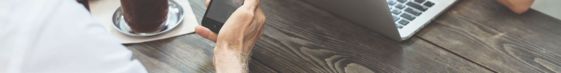 Business man looking at IT Security Services on his phone