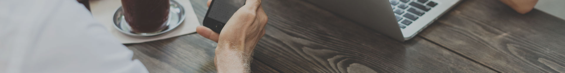 Business man looking at IT Security Services on his phone