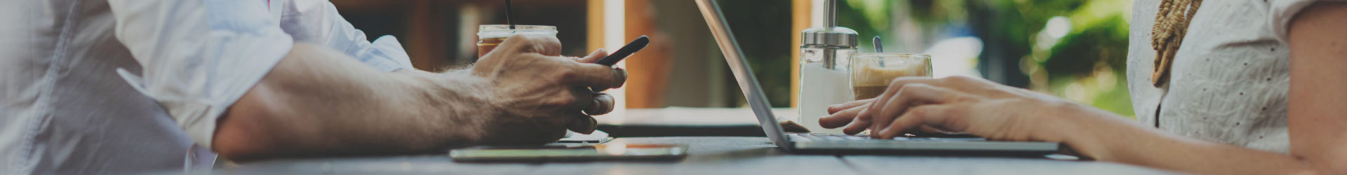 Man and woman working on their devices