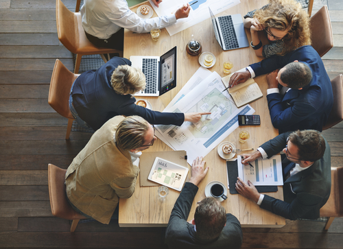 IT Security professionals sitting around a table discussing Cybersecurity