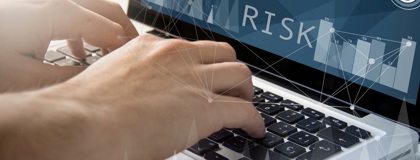 Close up of an Information security managers hands typing on a laptop establishing structured risk management practices