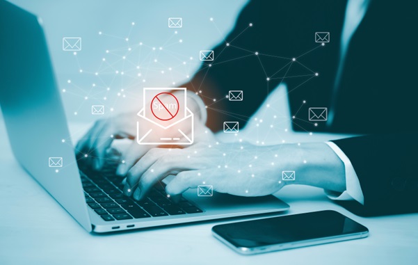 Business man working on a laptop conducting a email security & phishing threat assessment