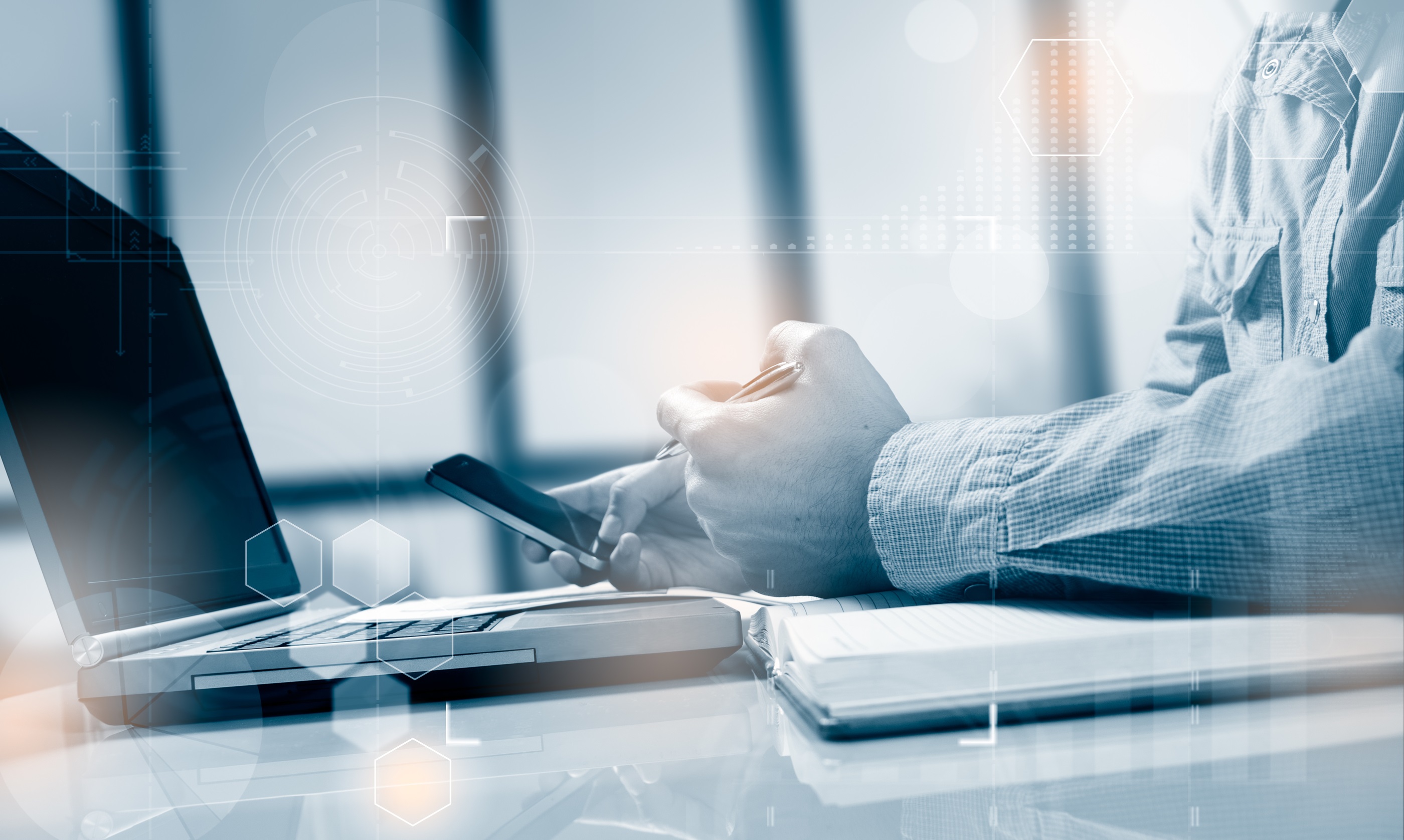 A business man working on a laptop about to make a call for IT incident response assistance