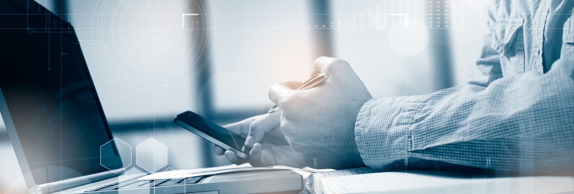 A business man working on a laptop about to make a call for IT incident response assistance