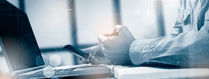 A business man working on a laptop about to make a call for IT incident response assistance