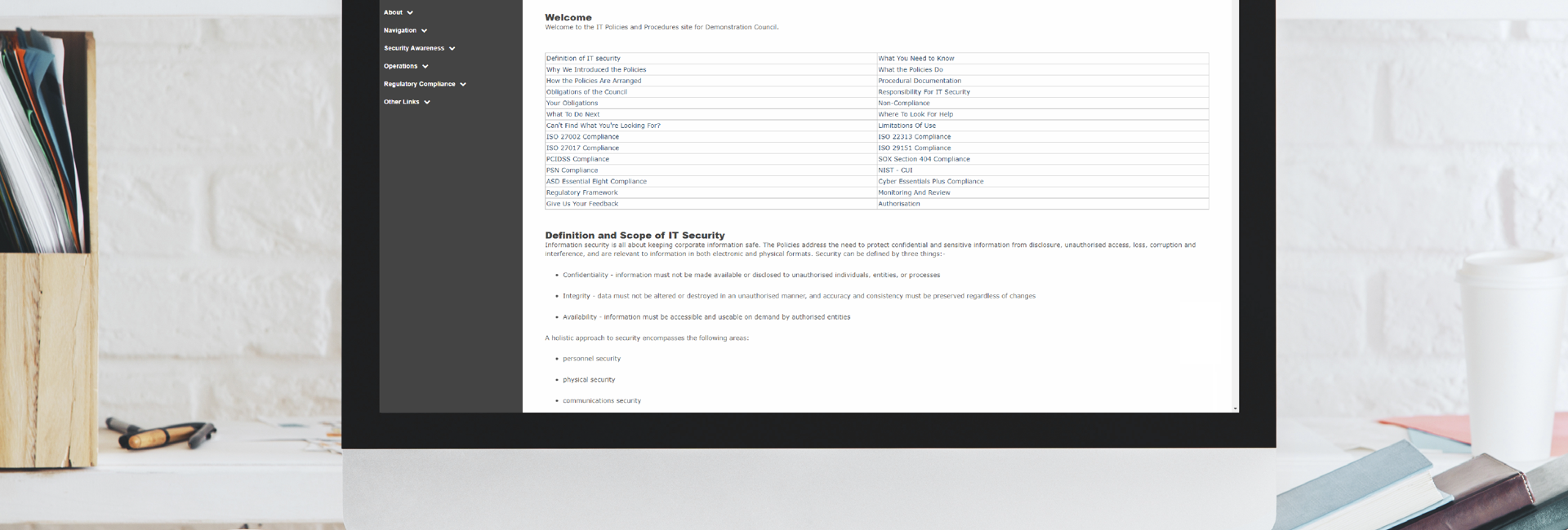 Desk with a monitor displaying the IT Policy Management as a Service platform