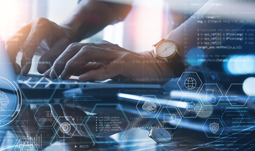 A mans hands typing on a laptop keyboard conducting a pen test
