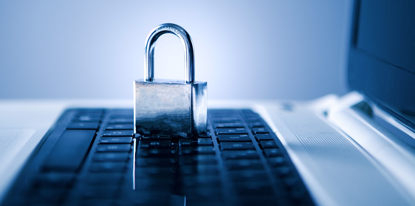 A close up of a padlock on a laptop keyboard, symbolising strong resilience through vulnerability management