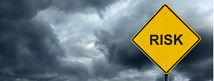 Yellow road sign with the word risk on it