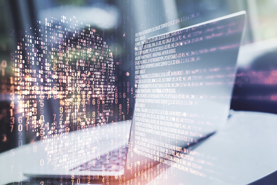 A laptop on a desk with an overlay of numbers and letters forming a skull, illustrating vulnerabilities a hacker could exploit and how penetration testing can identify them.