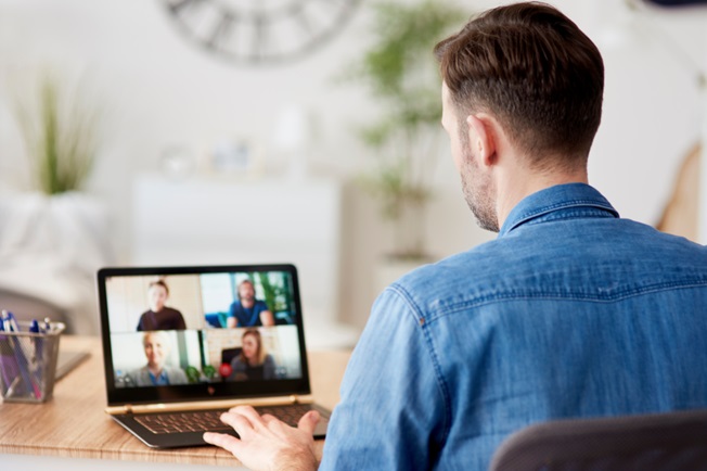 Laptop video conferencing teams member from home
