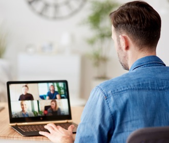 Laptop video conferencing teams member from home