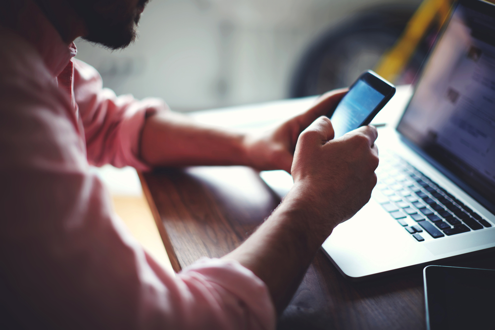 Man collaborating on a mobile phone using a secure Microsoft Teams app